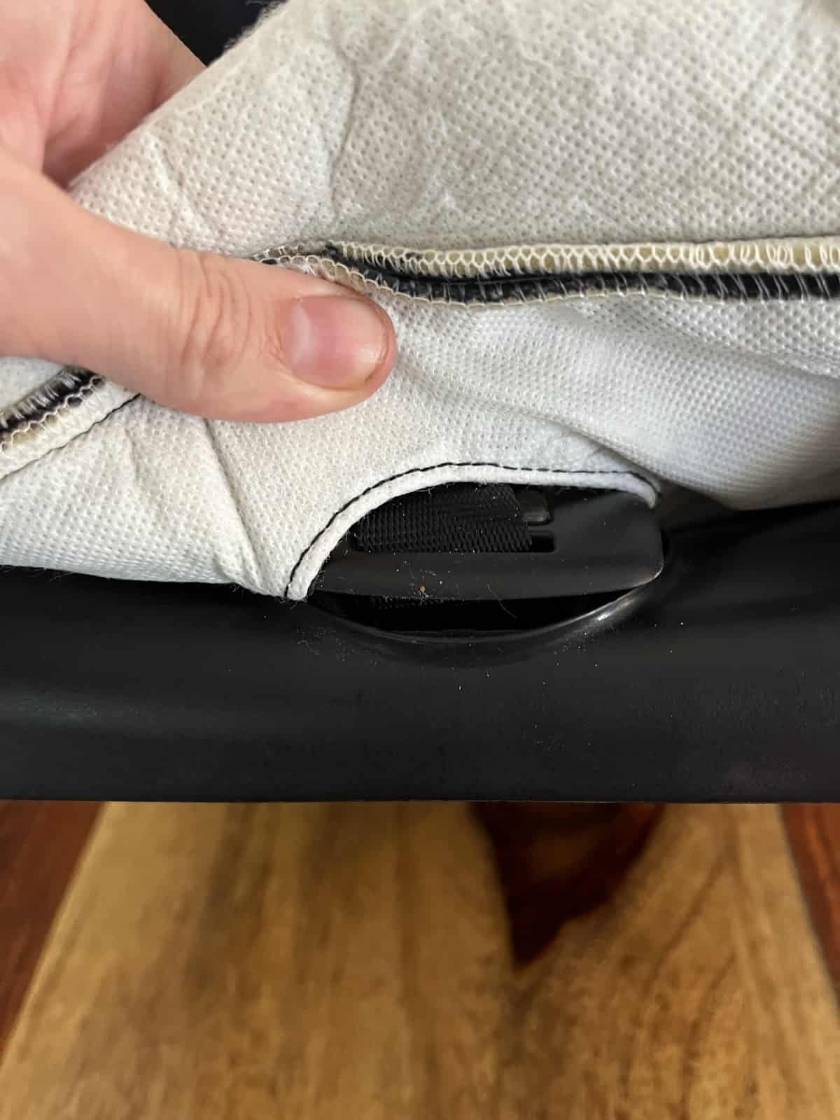 Stretch fabric around release button