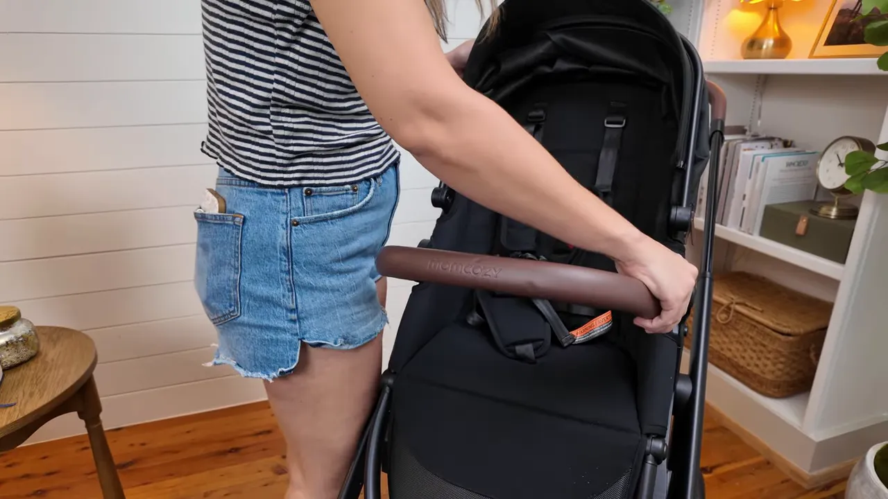 Bumper bar attached to the toddler seat, one-hand open shown
