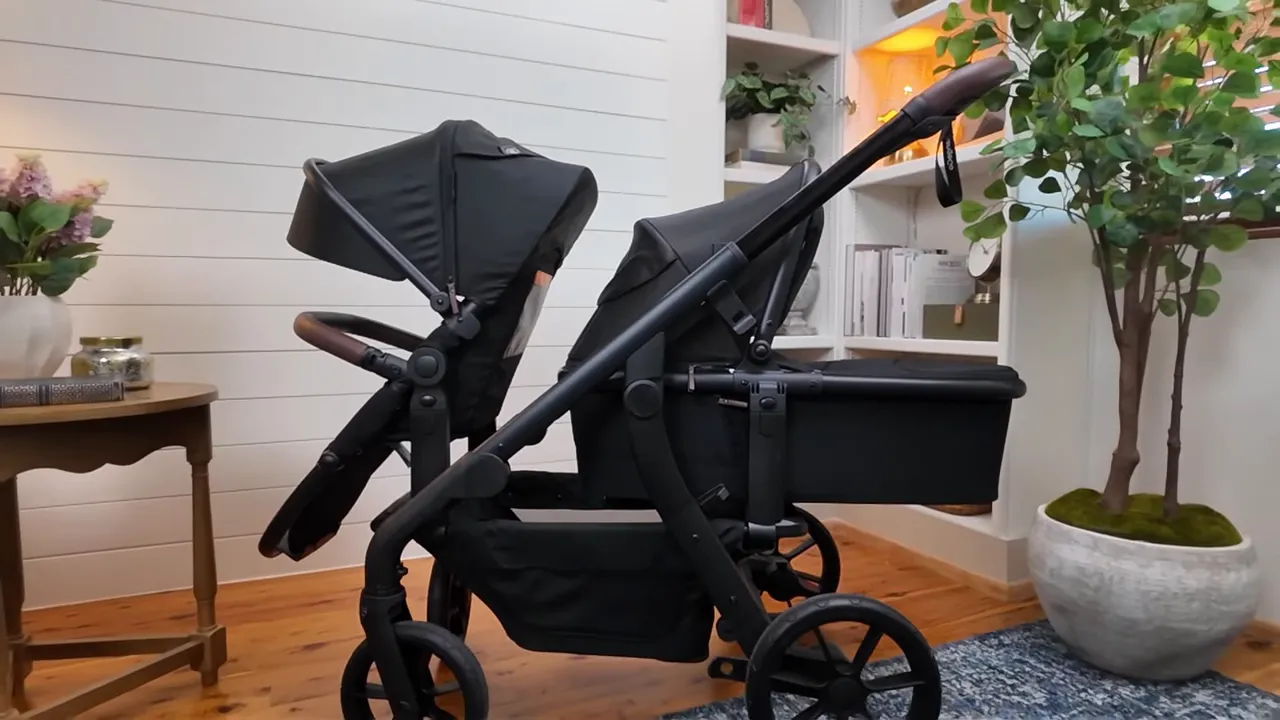 Momcozy ChangeGo stroller with bassinet attached, box contents shown